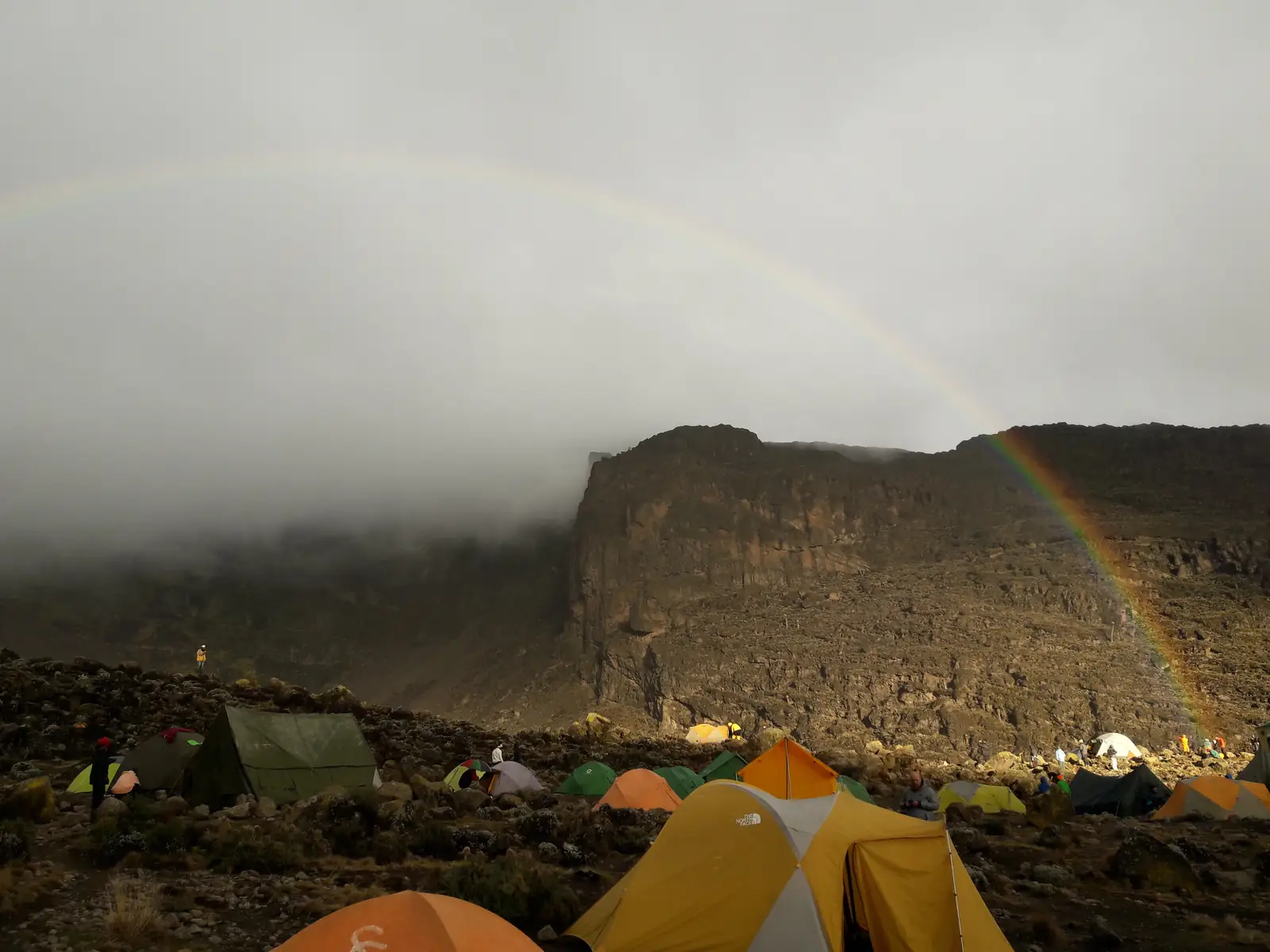 Tents at Barranco Camp with a rainbow over the Barranco Wall