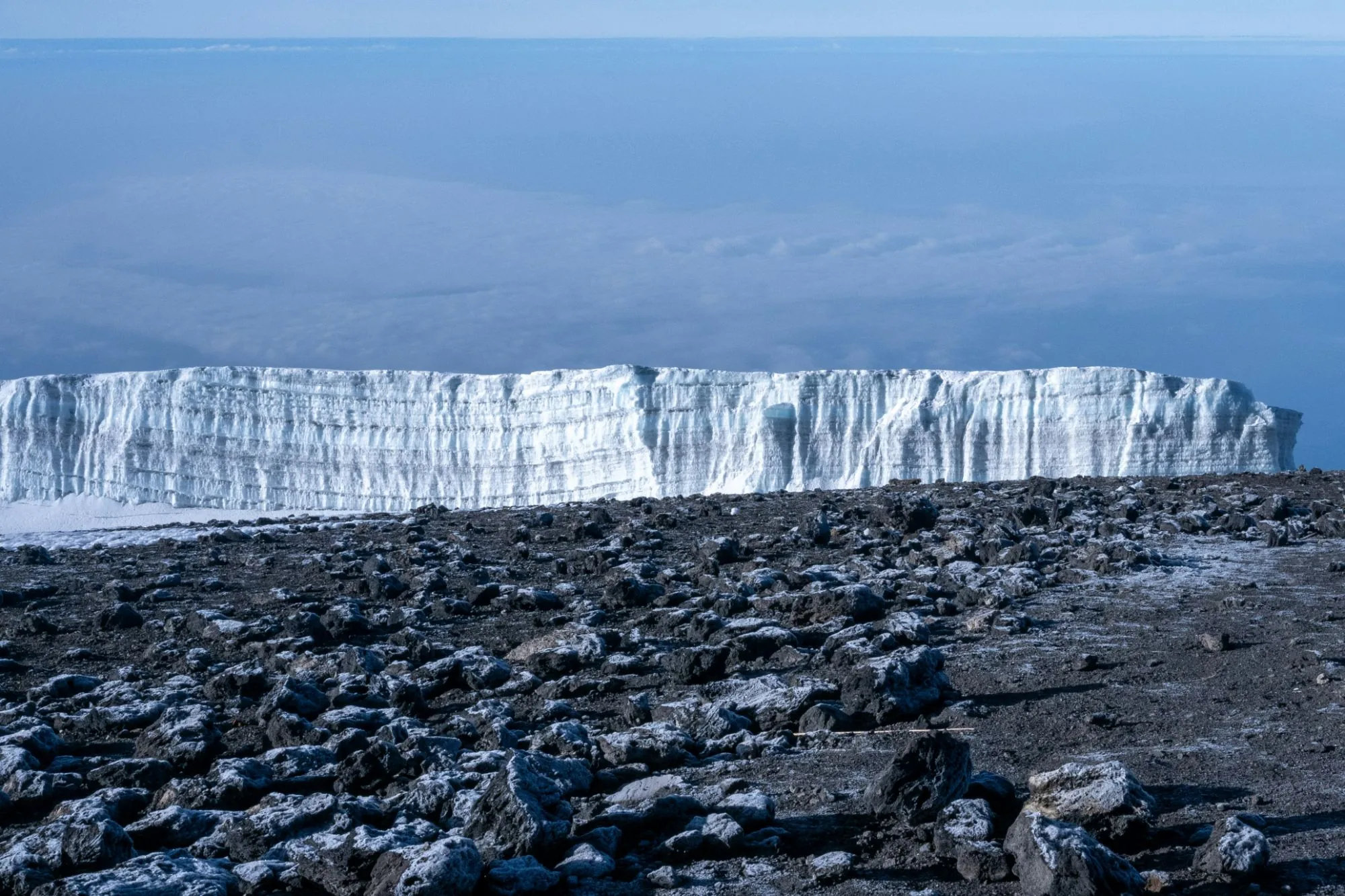 A glacier on the summit plateau of Kilimanjaro above a sea of clouds