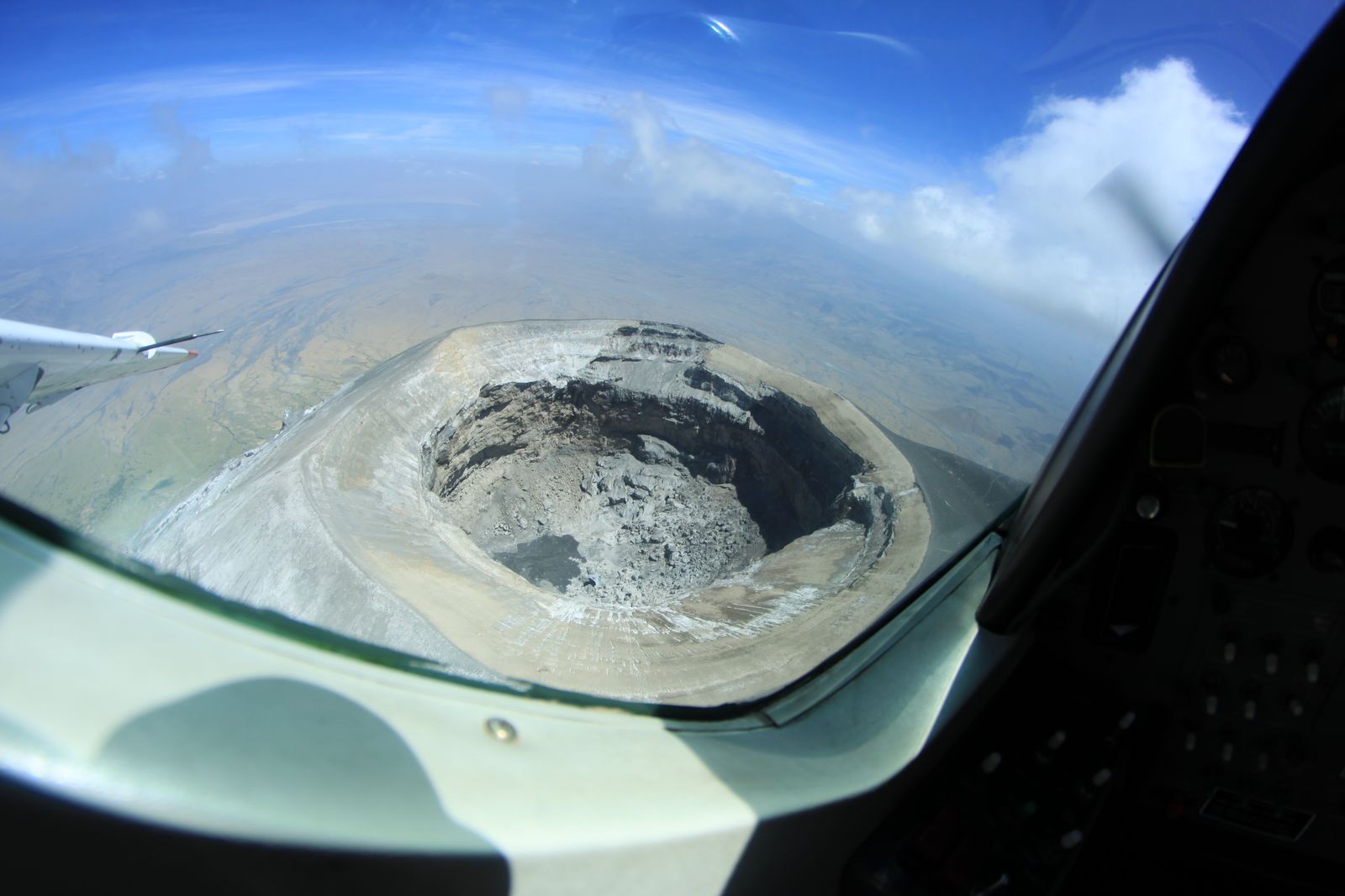 Aerial view into the grey-white summit crater of Ol Doinyo Lengai